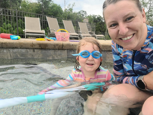 little girl and her mother in the pool