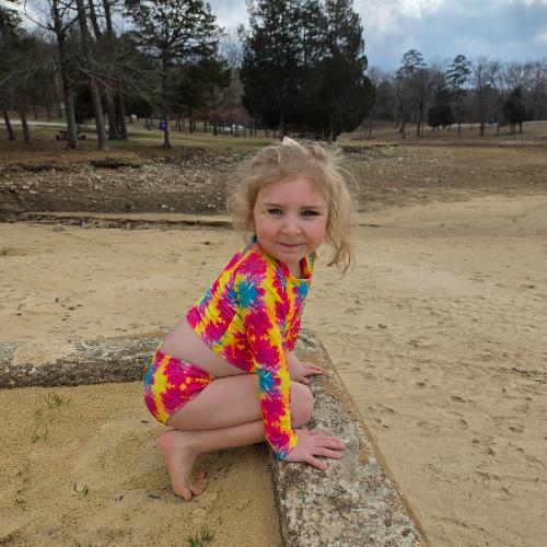 Girl crouching in splatter swimsuit