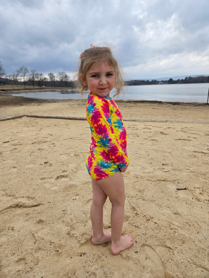 Toddler girl in neon long sleeve rash guard at the lake
